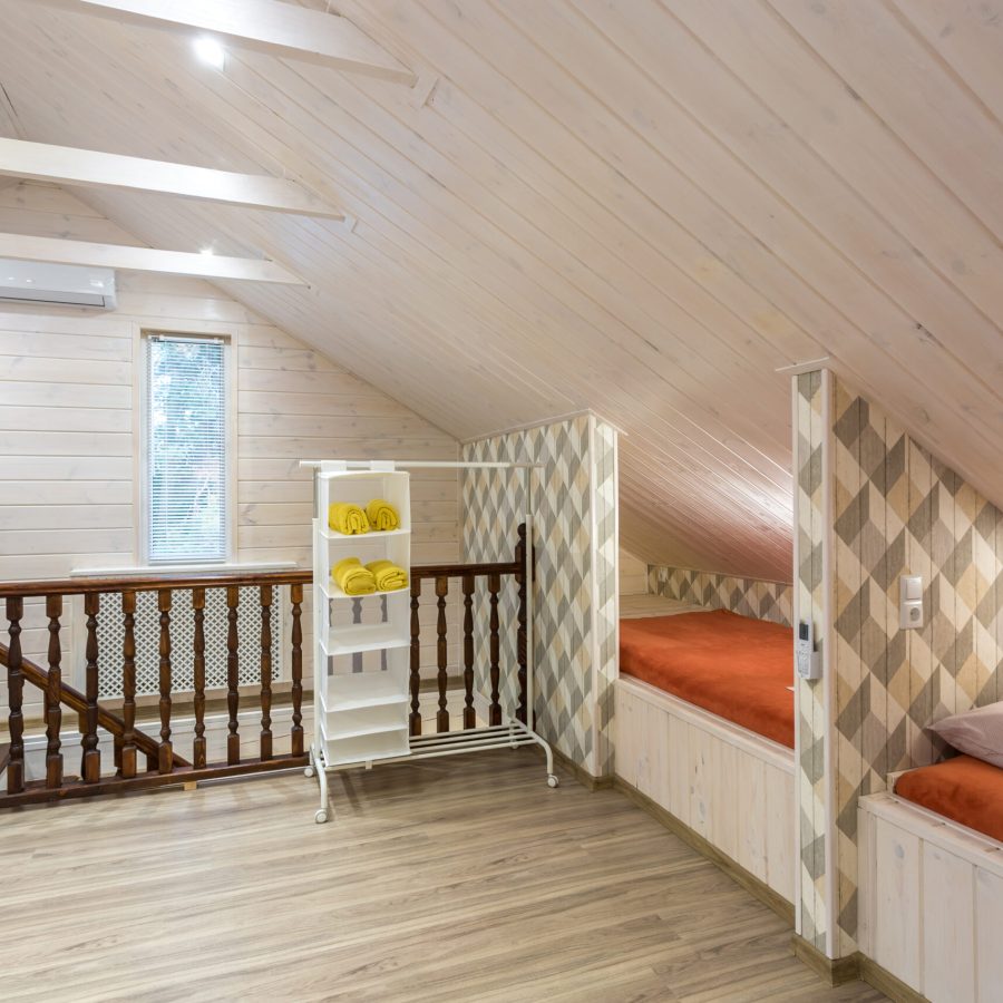 rows of wooden beds in a modern eco hostel with amenities